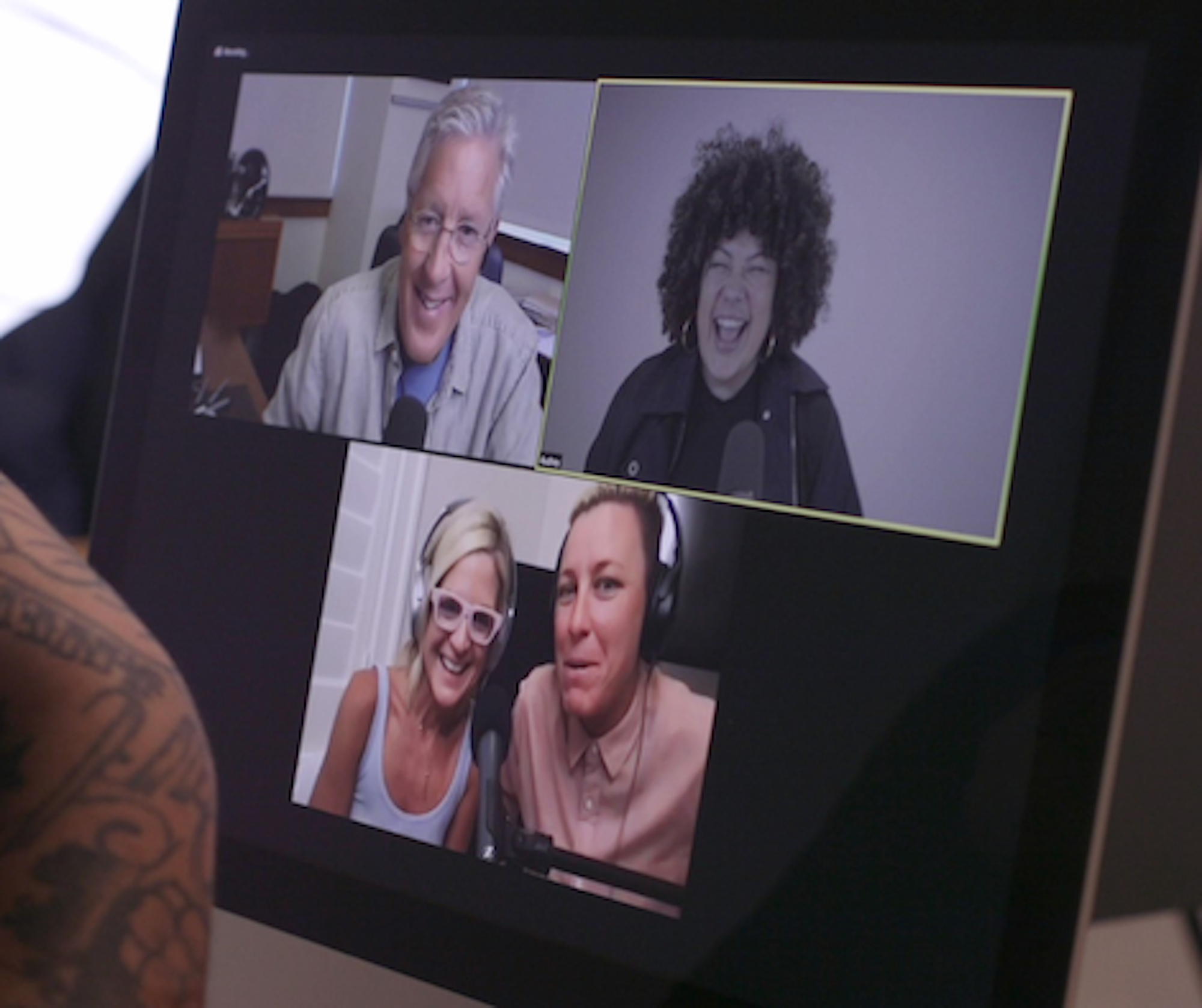 A recording session on screen, four people in separate rooms, laughing.